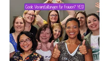 Gruppe von Frauen, die mit einer Daumen-Hoch-Geste lächeln.