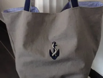 Cloth bag with anchor, half open, striped lining.