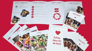 Food-themed booklets and cards on red background.