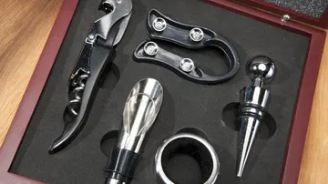 Wine accessory set in box on table.