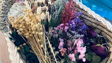Basket filled with colorful dried flowers.
