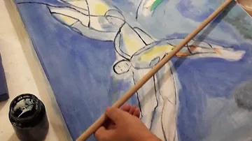 Person painting abstract art with a brush.