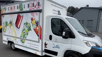 Mobile cocktail bar truck parked outdoors.