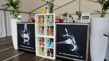 Outdoor cocktail bar with drinks on display.