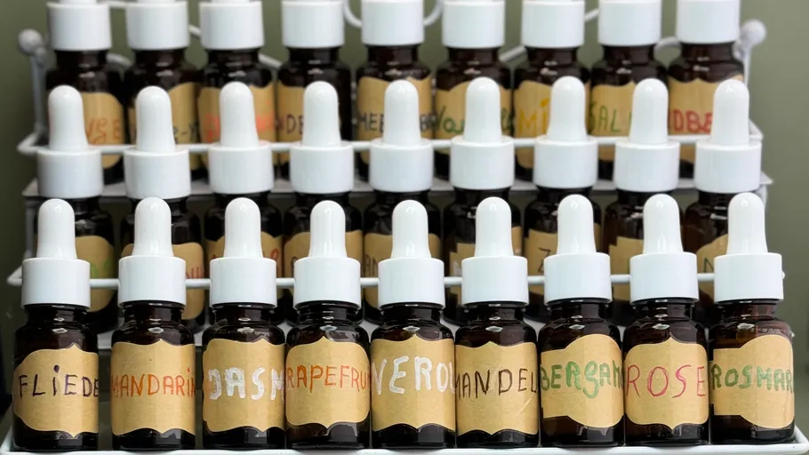 Dropper bottles labeled with different names on shelf.