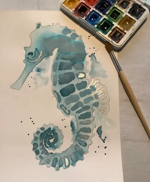 Watercolor seahorse painting with paint palette.