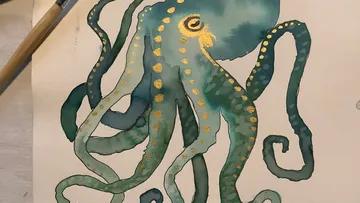 Watercolor painting of an octopus with gold details.