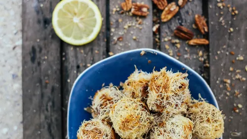 Plate of shredded pastry desserts on wood.