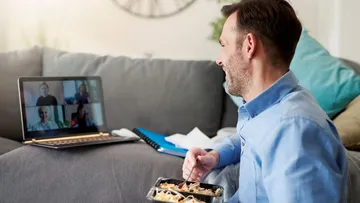 Man eating food while on a video call.