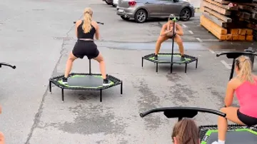 People exercising on trampolines outdoors.