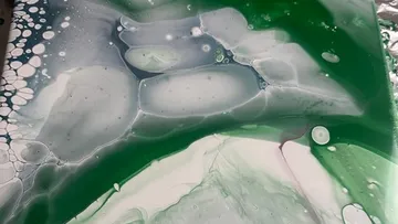 Abstract green and white fluid art.