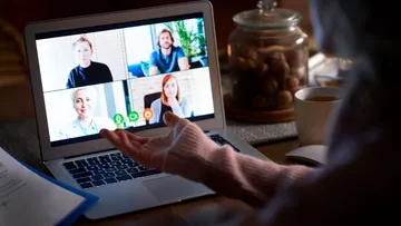Person on laptop video call with four others.