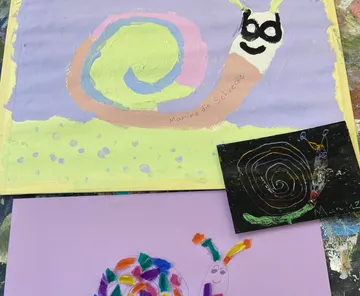 Colorful children's snail artwork on display.