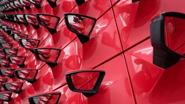 Red car mirrors in geometric pattern.