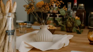 Vase with flowers on dining table