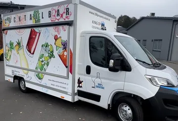 Decorated cocktail bar truck on street.
