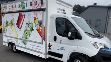 Cocktail bar truck with colorful drinks graphics.