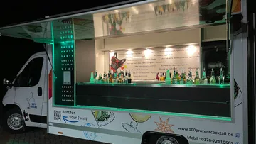 Mobile bar truck displaying various liquor bottles.