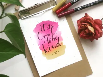 A piece of paper with the words “It's cool to be kind” is there.