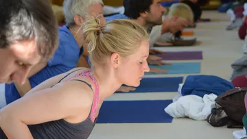 People practicing yoga in a group session.