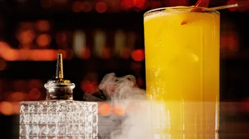 Tall yellow cocktail with smoke effect