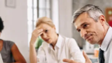 People in discussion around a table.