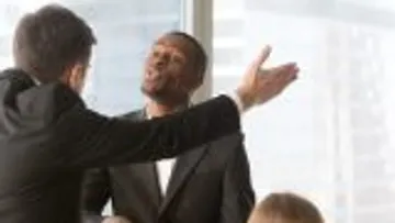 Two businessmen arguing in an office setting.