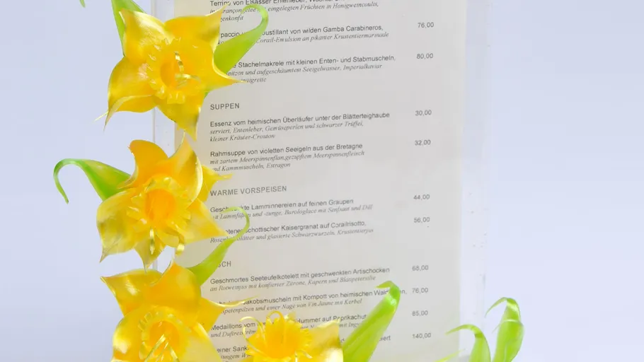 Decorative flowers beside a restaurant menu.