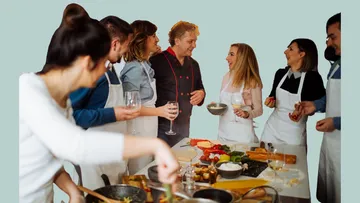 Gruppe von Leuten, die zusammen kochen und chatten.
