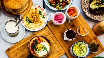 Variety of Middle Eastern dishes on wooden board.