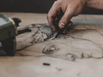Hand draw with chalk on brown paper in workshop.