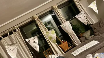 Wimpelketten hängen in einem Wohnzimmer.