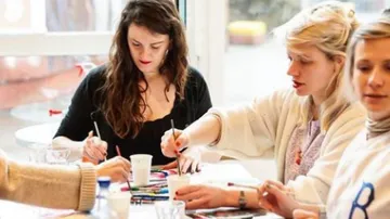People painting at a table together.