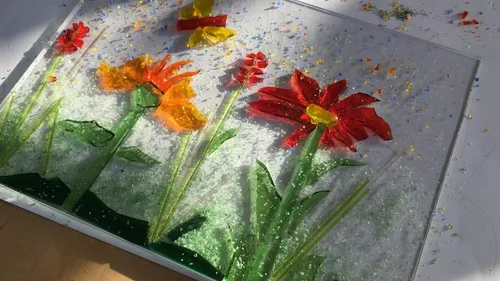 Colorful glass art with flowers and butterfly.