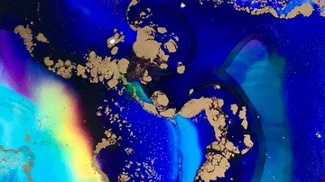 Abstract cosmic pattern with blue and gold swirls.