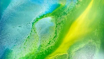 Abstract fluid art in blue, green, yellow.