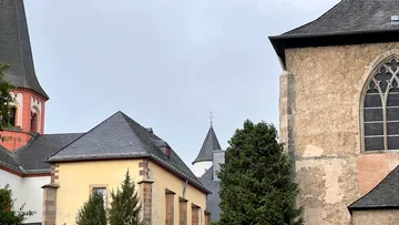 Old church buildings with slate roofs.