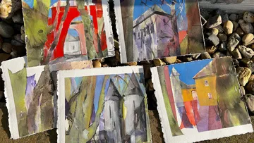 Five colorful abstract paintings on stones.