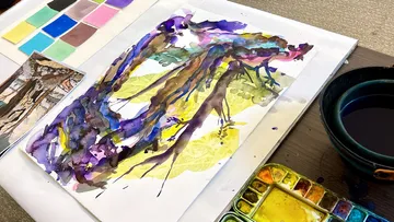 Watercolor painting of abstract trees on table.