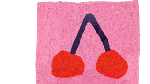 Pink towel with red cherries design.