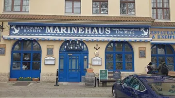 Marine-themed restaurant entrance with sign.