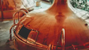 Large copper brewing vat in brewery.