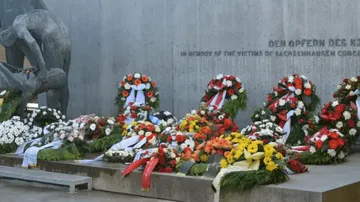 Wreaths placed at a memorial wall.