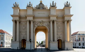 Historic archway with columns and sculptures.