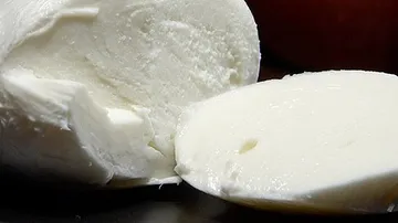 Sliced mozzarella cheese on table.