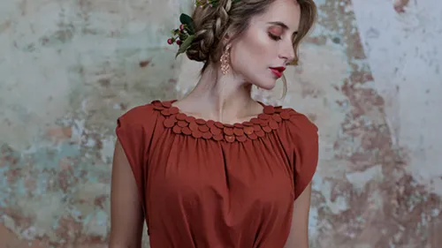 Woman in red dress with flower in hair.