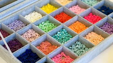 Colorful beads organized in a divided tray.