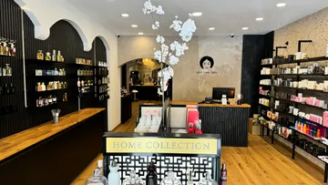 Perfume shop interior with shelves of products.