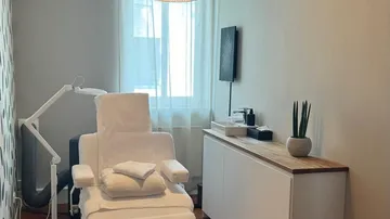 Spa room with chair and cabinets.