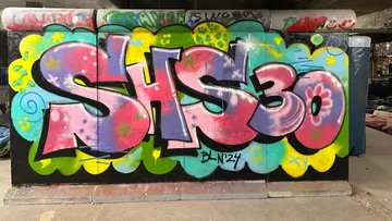 Colorful graffiti with 'SHS 30' on a wall.